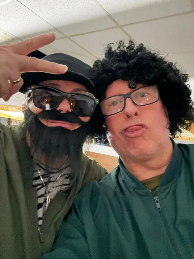 Two performers posing backstage