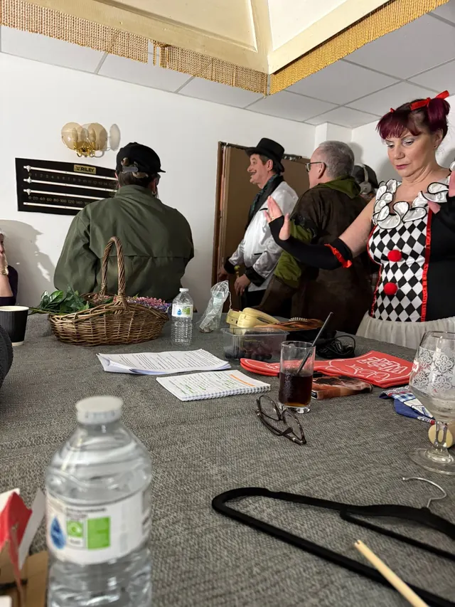 Cast members gathered around the rehearsal table